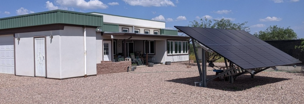 A ground-mounted PV system powers the home’s energy needs and contributes to net-positive energy efficiency.